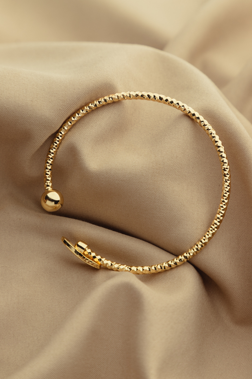 Gold Bracelet on Brown Satin Cloth